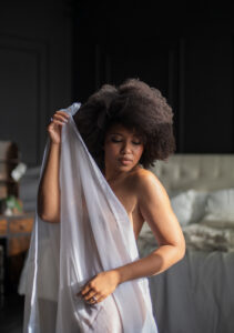Boudoir photo of woman with sheer sheet
